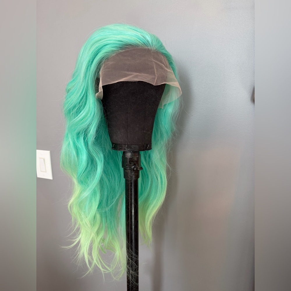 Brand new 13x1.5 aqua synthetic lace front wig with light green tones. 24 in